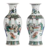 A pair of Chinese famille verte baluster shaped vases, decorated with animated scenes, H 46,5 cm