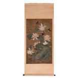 A Chinese scroll painting, watercolour on textile, depicting birds and water lilies, signed,