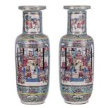 A pair of Chinese turquoise ground famille rose rouleau shaped vases, the roundels decorated with