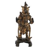 A Chinese gilt bronze temple guard with traces of polychromy, probably 18thC, H 24,5 cm (damage)