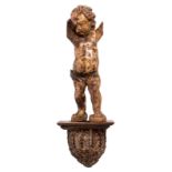 An early 18thC baroque sculpted pine angel with traces of polychrome paint; added a sculpted