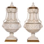 A pair of Neoclassical tinted biscuit vases and covers with brass mounts, H 52 cm (minor damage)