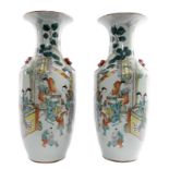 A pair of Chinese polychrome vases, decorated with ladies and children playing in a garden, H 57,5