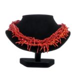 A red coral necklace out of multiple component parts and with a gilt extender, total weight ca. 80g,