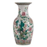 A Chinese famille rose vase, overall decorated with flower branches and butterflies, 19thC, H 45,5