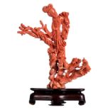 A Chinese red coral sculpture depicting a Guanyin, with a matching base, H with base 25,5 cm,