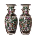 A pair of Chinese polychrome stoneware vases, decorated with warriors, marked, H 46 cm (restored)