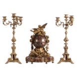 A Neoclassical red Cerfontaine marble clock with love symbolism and two accompanying bronze