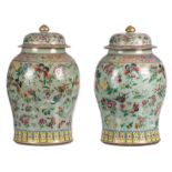 A pair of Chinese celadon groud famille rose vases and covers, overall decorated with butterflies,