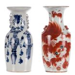 A Chinese iron red vase, decorated with Fu-lions, marked, 19thC; added a Chinese blue and white vase