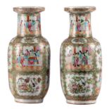 A pair of Chinese rouleau shaped Canton famille rose vases, decorated with courtscenes, H 44,5 -