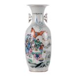 A Chinese polychrome vase, decorated with an animated scene, H 58 cm (cracks to the bottom)