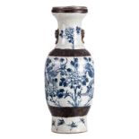 A Chinese blue and white stoneware vase, decorated with dragons and flower branches, marked,