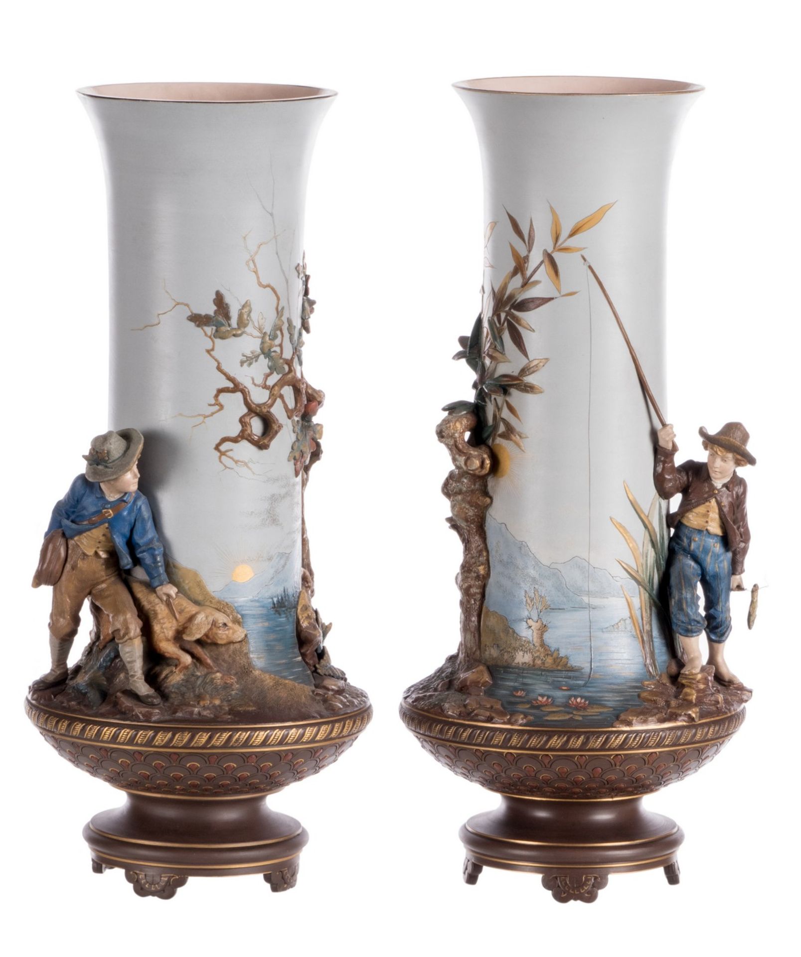 A pair of red stoneware vases, polychrome and partly cold painted relief decoration depicting