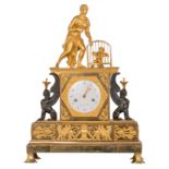 A Neoclassical gilt and patinated bronze mantel clock, the clock itself flanked by two sphinxes, the