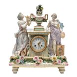 An elegant polychrome decorated porcelain mantel clock, marked, H 39,5 - W 33,5 - D 12 cm (minimal