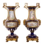 A pair of Neoclassical vases in Sèvres-porcelain, blue royale ground, the front with gilt cartouches