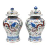 A pair of Chinese polychrome vases and covers, decorated with dragons, H 44 - 46 cm (covers not