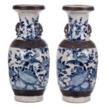 A pair of Chinese blue and white crackleware vases, decorated with birds on flower branches, marked,