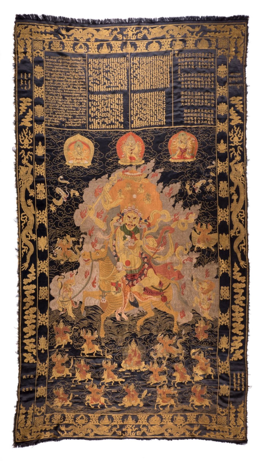 An extraordinary Chinese silk tapestry depicting scenes of a god, dragons and auspicious symbols