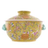 A Chinese yellow ground famille rose bowl and cover, decorated with peaches, bats and shou