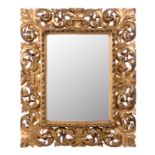 A wall mirror in carved and gilt wood, 63 x 76,5 cm