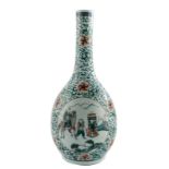 A Chinese famille verte bottle vase, floral decorated, the roundels with warriors, H 43,5 cm (chip