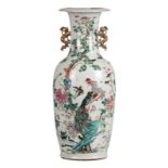 A Chinese famille rose vase, decorated with a phoenix, birds and flower branches, 19thC, H without