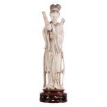 A Chinese ivory Guanyin, ivory with coloured engraving decoration, marked, on a matching wooden