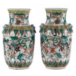 A pair of Chinese famille verte vases, overall decorated with warriors, 19thC, H 35 cm