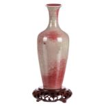 A Chinese sang de boeuf red-grey glazed miniature vase, on a matching wooden base, with a Kangxi