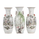 A pair of Chinese famille rose and polychrome decorated vases with a galant garden scene, signed (