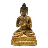 A Chinese gilt bronze seated Buddha, traces of polychromy, H 17,5 cm (minor damage)