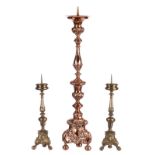 A baroque pair of bronze church candelabras, H 59 cm, (one with restoration); added a ditto red