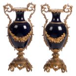 A pair of Nap. III-style ornamental vases in porcelain, blue royale ground and impressive gilt