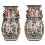 Two Chinese yellow ground famille rose vases, the roundels decorated with court scenes and birds