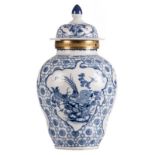 A Chinese blue and white floral decorated vase and cover, the roundels decorated with birds and