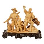 A Chinese ivory group depicting a rural scene, on a carved wooden base, first half 20thC, H 22,5 (