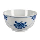 A Chinese blue and white floral decorated bowl, marked Kangxi and period (chips to the rim)