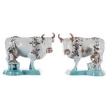A pair of Dutch Delftware cows with milk boy and milkmaid, the base turquoise glazed, polychrome