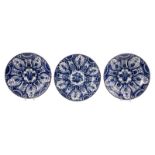 A pair of blue and white decorated Dutch Delftware plates with profiled edge, one marked 'De