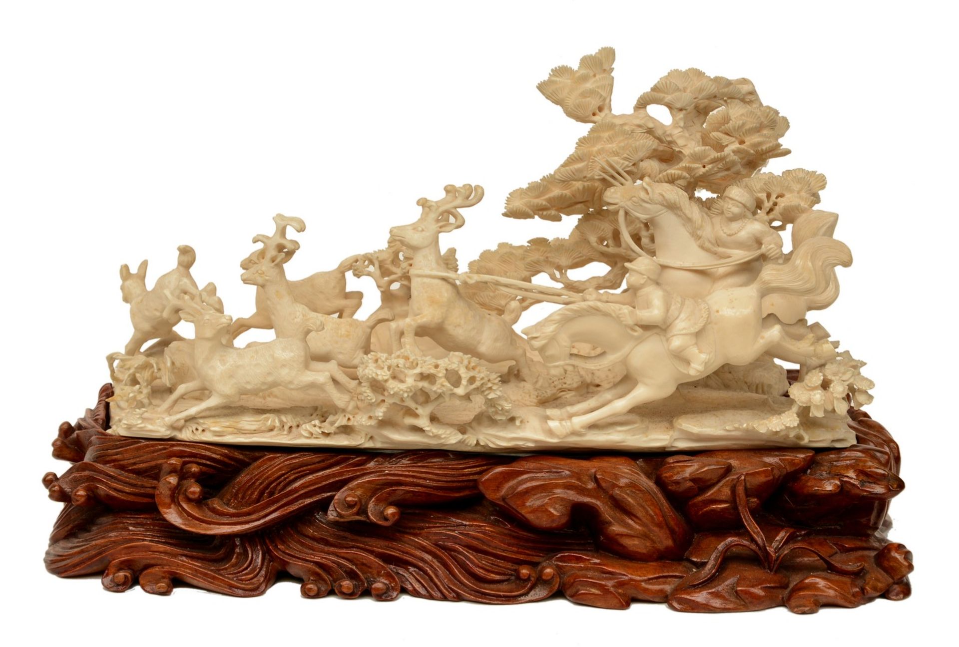 A Chinese ivory group depicting 'young heroes hunting for reindeers' on a carved wooden base,