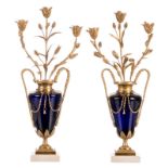 A pair of vase shaped blue glass neoclassical candlesticks, top in the form of a bouquet of flowers,