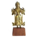 A Sino-Tibetian gilt bronze Buddha on a wooden base, Qianlong, H 21 (with base) - 17 cm (without