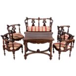 A late 19thC Neo-Renaissance walnut parlor set composed of a sofa, a confident, two corner chairs