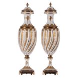 A pair of relief gilt porcelain vases and covers with gilt brass mounts, marked Sèvres, H 53,5 cm