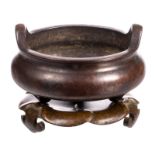 A Chinese bronze miniature incense burner on a ditto base, marked, H 4,5 (with base) 3,5 (without