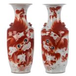 A pair of Chinese iron red vases, decorated with Fu lions, one vase marked, H 57 - 57,5 cm