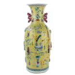 A Chinese yellow ground famille rose vase, decorated with moulded antiquities and flower branches,