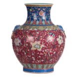 A Chinese globular vase, pink ground, polychrome with floral motives, the handles relief